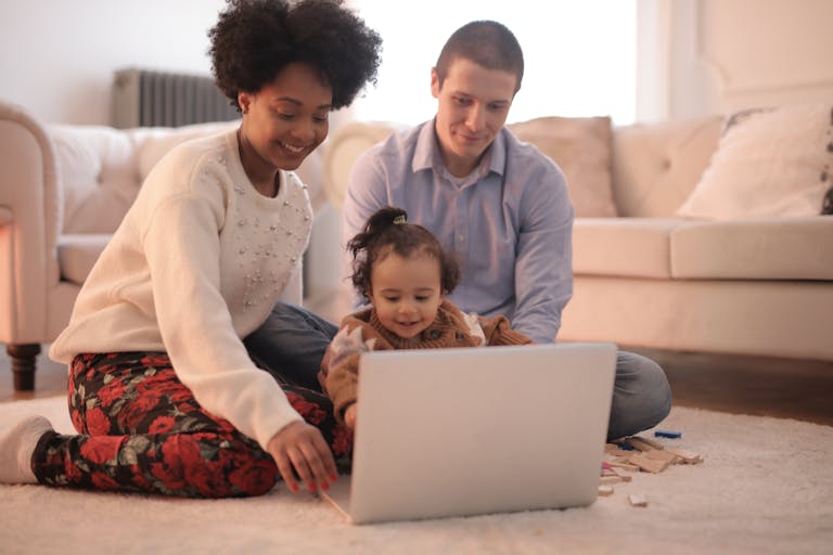 Photo of Family Sitting on Floor While Using Laptop looking at mortgage options and borrowing capacity