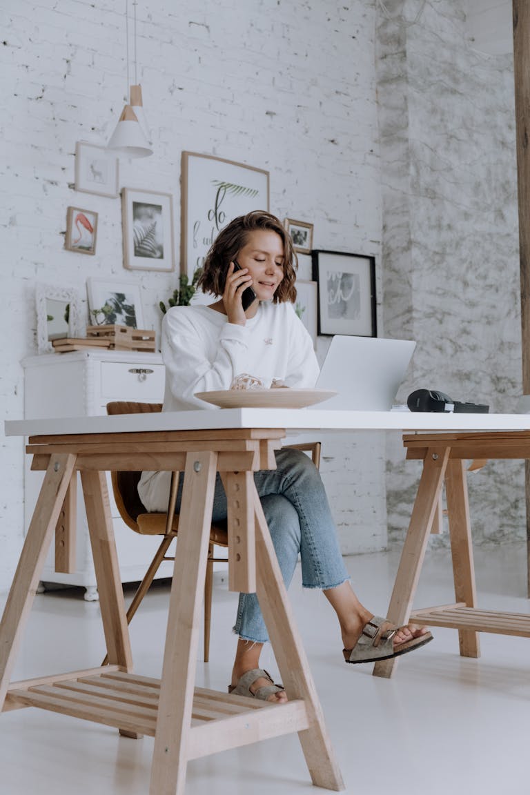 Self employed woman talking to perth mortgage broker about home loan from her home office