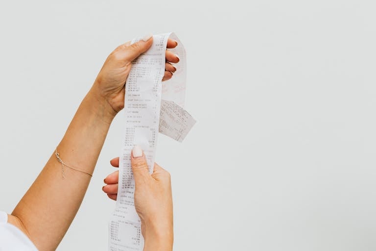Woman Holding a Receipt after being asked to calculate living expenses by mortgage broker