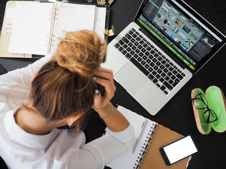 Woman Sitting in Front of Macbook after applying for a home loan