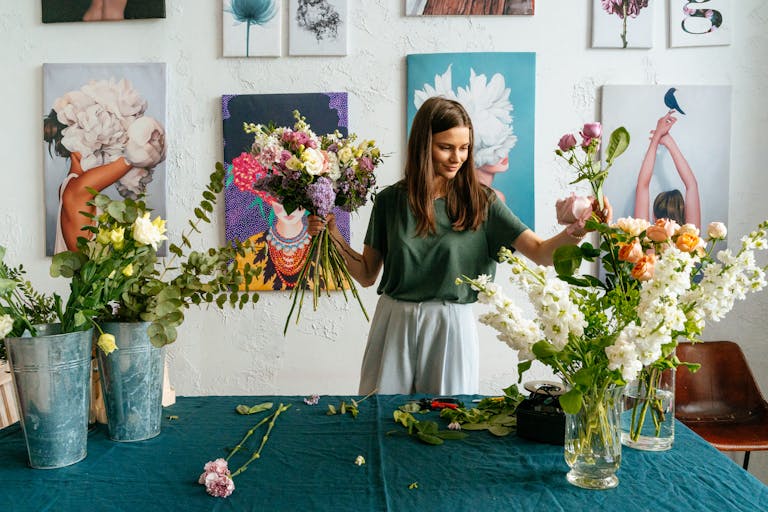 Florist arranging vibrant floral bouquets in a creative art studio setting as she wonders how she can set up an offset account with her mortgage broker perth