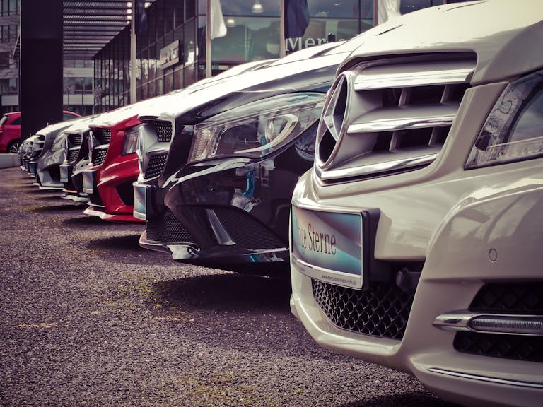 Luxury cars at a dealership as car buyers and home owners consider if they should refinance a car loan and how a mortgage broker can help