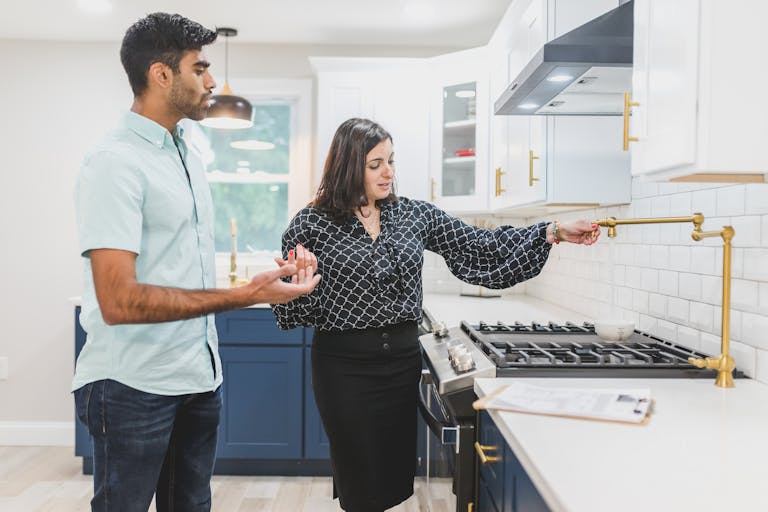 Real estate agent Perth showing a modern kitchen interior to a client who is ready to become a property investor.