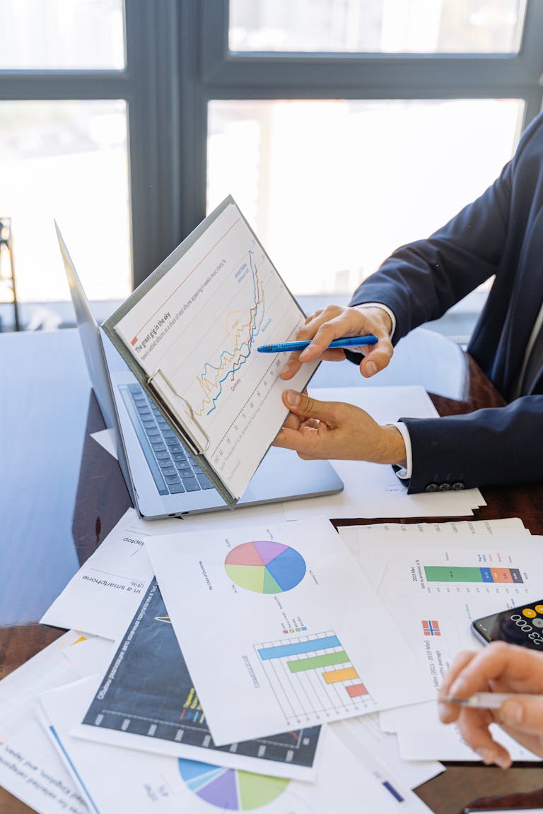 Business professionals discussing superannuation and charts in an