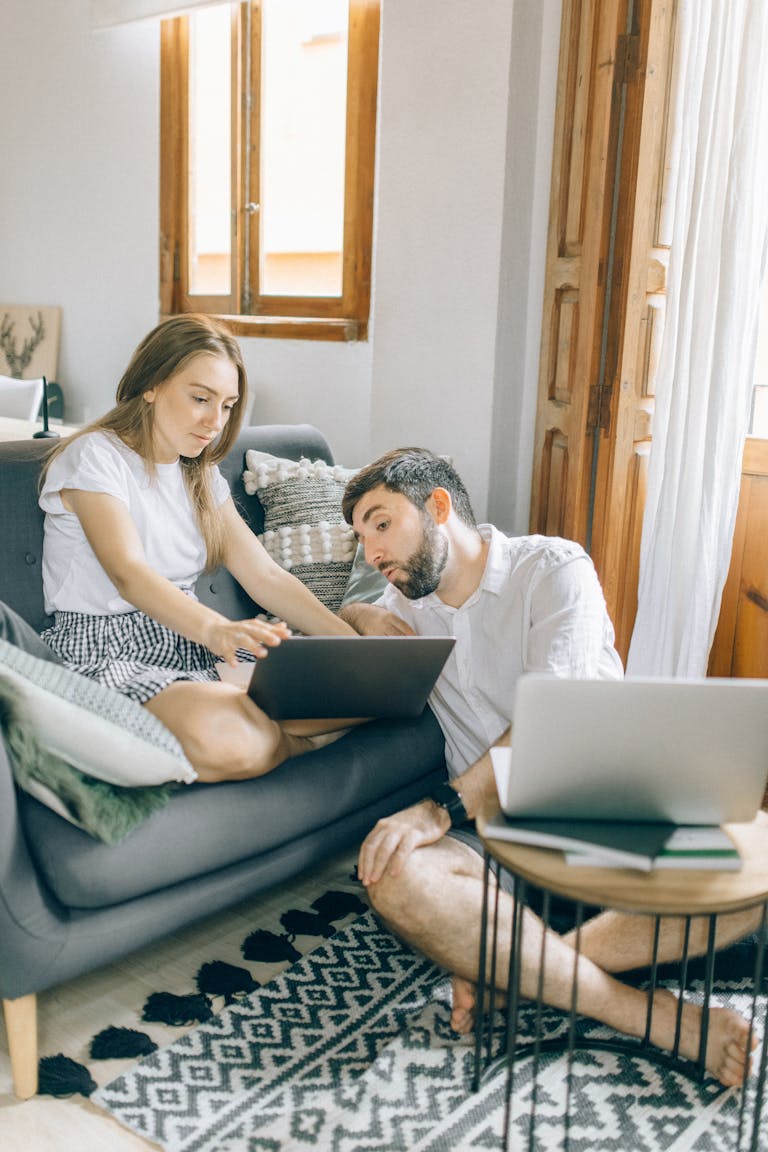 A young couple checking their home loan interest rate after the RBA rate cut announcement
