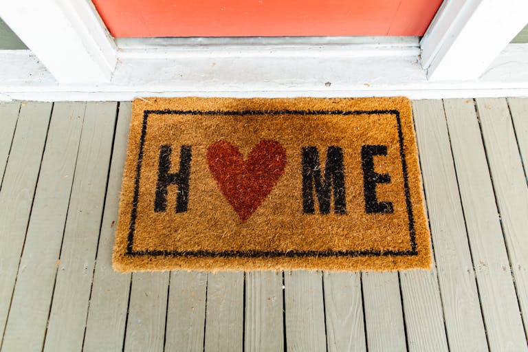 Doormat with 'Home' written and heart symbol for first homebuyers applying for a home loan
