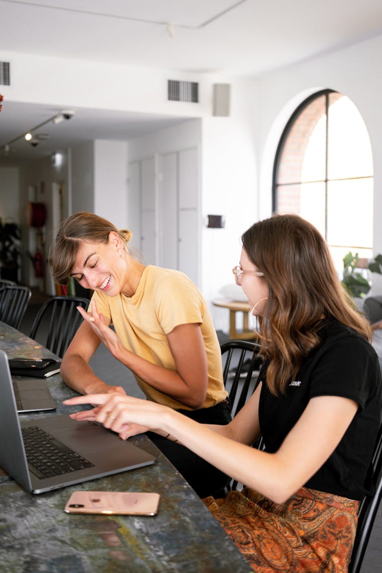 Two women engaged in a discussion about their home loans at a modern office setting