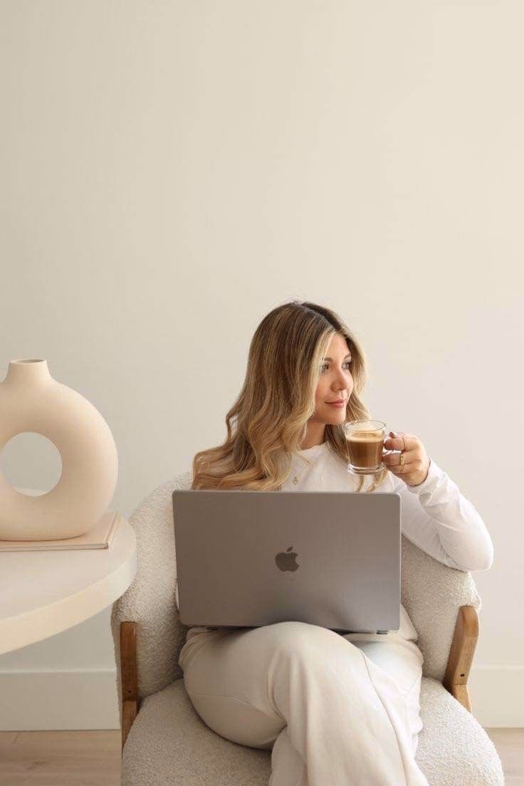 woman sitting at home on laptop with coffee researching refinancing options in perth