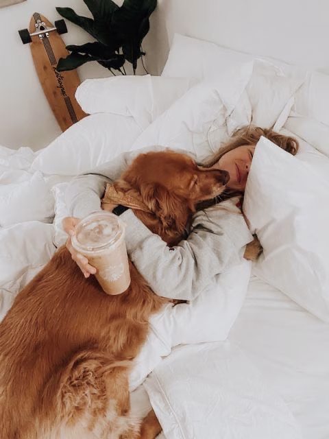 first home buyer in her bed with dog and coffee after getting finance guidance for first home buyers in perth and Australia from mortgage broker perth