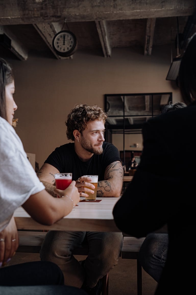 Group of friends sharing drinks at a rustic pub, enjoying different craft beers and comparing their home loan interest rate