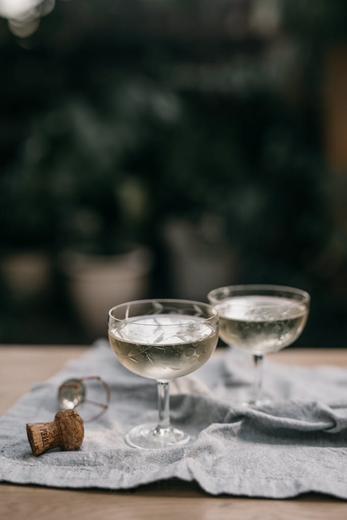 Two champagne glasses on a tablecloth creating as couple celebrate getting offer accepted in heated Perth property market update